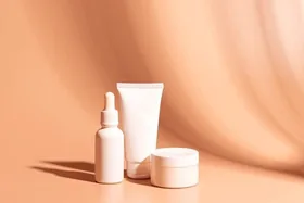 Skincare bottles on a peach backdrop